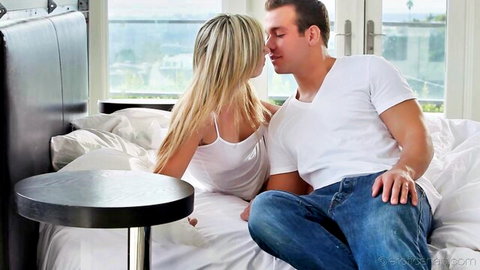 Lilly Banks sharing a passionate morning kiss with a man in bed
