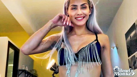 Veronica in sexy black fringe bikini top, smiling with platinum hair