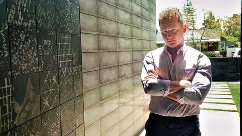 Ginger man in light shirt, arms crossed outside modern home, from Big Saggy Tits Blonde video