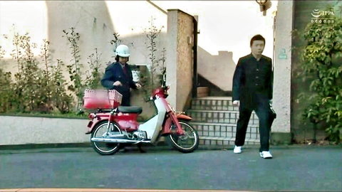 Plump Japanese housewife in helmet on red scooter with suited man outside home