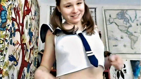 Cute freckled teen in tight schoolgirl sailor top and tie smiling teasingly on webcam