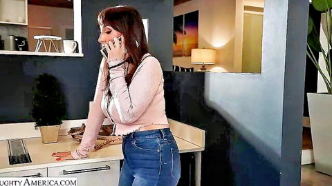 Melody Mynx in tight jeans and sweater, talking on phone seductively