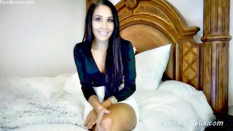 Mean Girl Bella teases with deep cleavage tits and sexy thighs in black top white shorts on bed