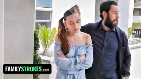 Ponytailed skinny teen stepdaughter in blue off-shoulder top with bearded stepdad's arm around her outdoors