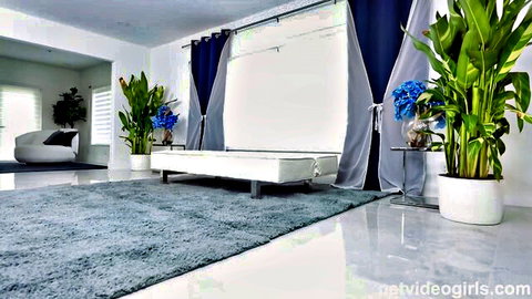 Elegant bedroom scene with white sofa and blue accents for adult video Can Get It