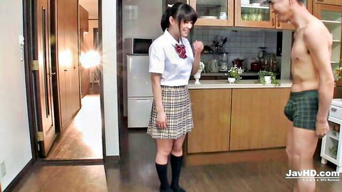 Cute Japanese schoolgirl in plaid skirt and knee socks teases shirtless muscular guy in green boxers in kitchen
