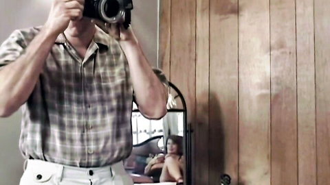 Mature redhead granny topless and alluring in mirror for thrilling XXX photo shoot