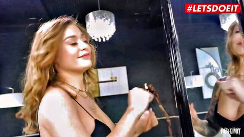 Misha Maver in black lingerie smiling in mirror, red wavy hair
