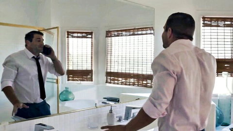 Businessman on phone in mirror, from Octavia Red's The Business Trip