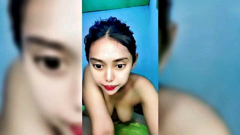 Nude Asian woman with dark hair squatting seductively in amateur solo