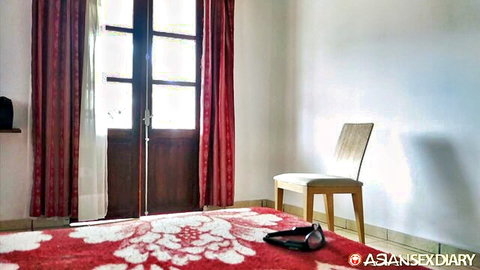 Indonesian girl Tatiana's elegant bedroom with red accents and high heels
