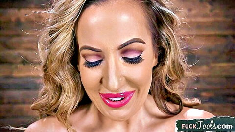 Seductive blonde MILF with glossy red lips and heavy makeup smiling teasingly