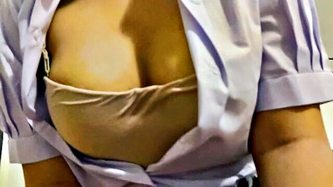 Busty Asian woman in unbuttoned purple blouse revealing beige bra cleavage