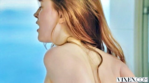 Sensual redhead teen with open mouth and bare shoulders topless by blue pool