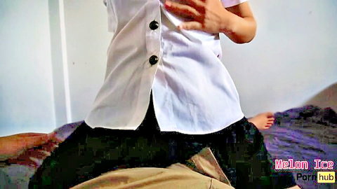Southeast Asian cutie in unbuttoned white shirt squeezes tits while straddling boyfriend on bed