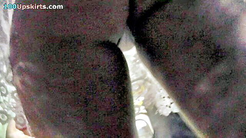 Auburn-haired beauty flashes g-string in candid upskirt view