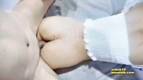 Close-up of Asian woman's exposed pussy and ass in white frilly diaper