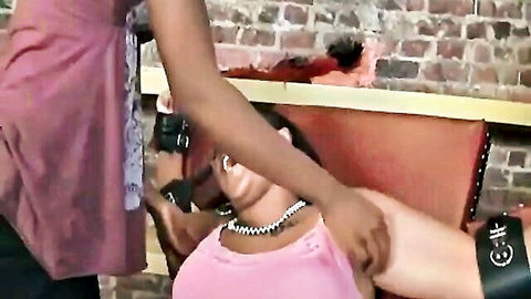 Ebony domme grabs bound ebony babe's arms in chair showing huge tits in torn pink top