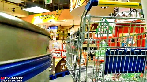 Empty supermarket aisle with shopping carts and colorful shelves in amateur store video
