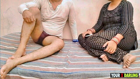 Chubby Indian wife in saree sits beside husband on bed spreading legs in tight maroon underwear showing cock bulge