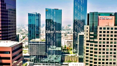 Panoramic Los Angeles skyline with modern glass skyscrapers and CIBC Bank under clear blue sky