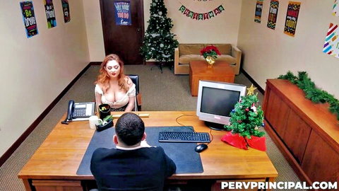 Chloe Cooper's busty redhead in low-cut top at Christmas office desk