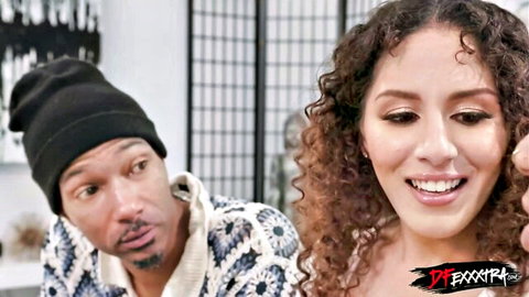 Smiling curly-haired Latina woman with Black man in teasing pose