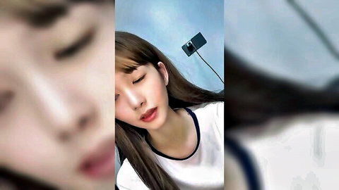Sexy Asian college girl puckers plump lips in teasing homemade selfie closeup