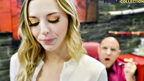 Lily Larimar close-up with intense gaze, blonde in white blouse, male performer behind in Lily Broken