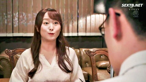 Japanese MILF housewife in white blouse puckers surprised lips at man on couch