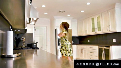 Brunette trans babe in yellow dress stands in modern kitchen, GenderX Films thumbnail