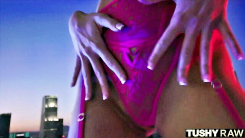 Hot blonde in pink lingerie teasing crotch in urban night scene
