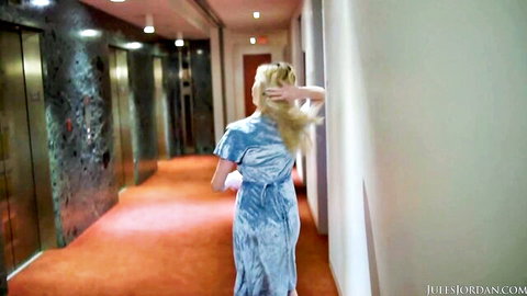 Blonde Lexi Lore in sexy blue velvet dress walking hotel hallway