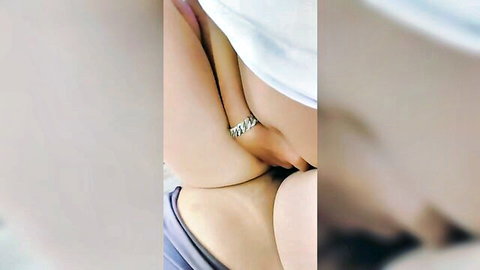 Close-up of Asian woman exposing shaved pussy with hand nearby in amateur solo tease