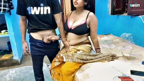Busty Indian woman in pink bra and yellow saree eyes man's hard cock held to her open mouth in homemade tease