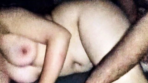 Amateur guy groping girl's exposed tits and hard nipple in bed.