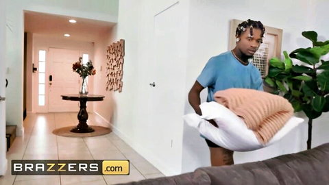 Black stud hiding his huge cock with orange pillow in living room