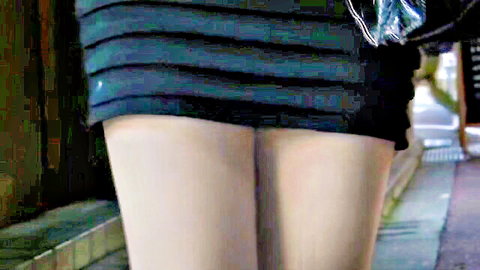 Skinny girl hikes up pleated skirt revealing bare ass and thighs outdoors