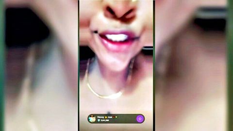 Close-up of sexy Indian webcam girl's parted lips smiling on live stream