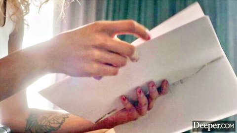 Scarlit Scandal in white top, holding envelope, teasing kink submission