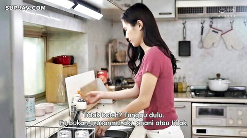 Ayaka Muto in pink top and white shorts, bending at kitchen sink