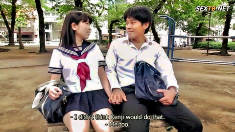 Japanese schoolgirl in uniform holding hands with man outdoors