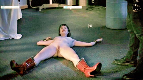 Naked brunette heroine restrained in red boots, spread eagle pose