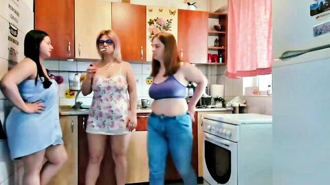 Three young women in casual lingerie and jeans chatting intimately