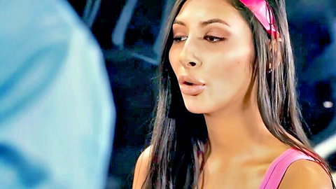 Seductive brunette with long hair in pink top and headband, teasing close-up