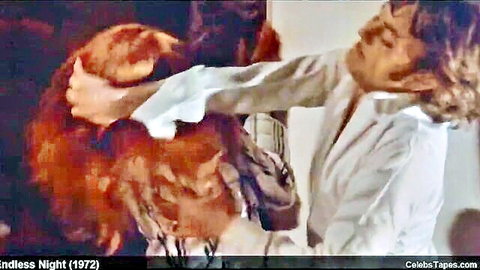 Blonde woman in white shirt grabbed from behind by furry beast in intense 1972 scene