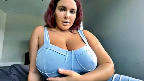 Curvy redhead MILF teasing massive overflowing tits in tight blue bra POV closeup