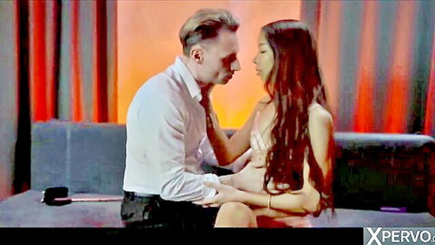 Marcello Bravo intimately touching petite Asian babe's chest in close embrace