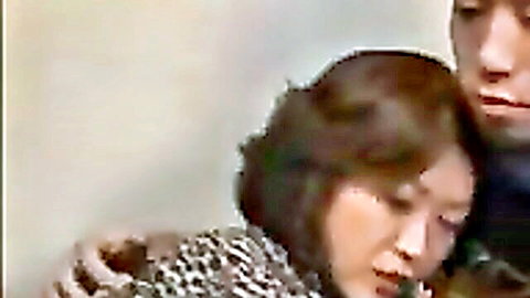 Japanese MILF and young stud in taboo close embrace, faces nuzzling passionately