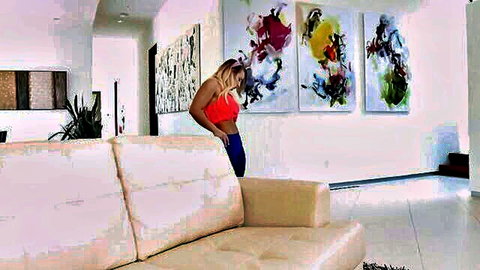 Blonde babe bends over sofa in red bra and tight blue yoga pants showing big ass